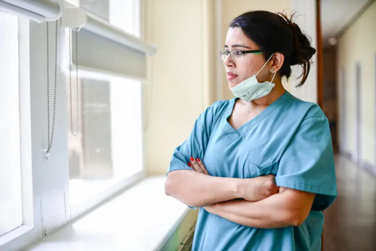 A healthcare-provider conducting a virtual consultation with a patient via laptop